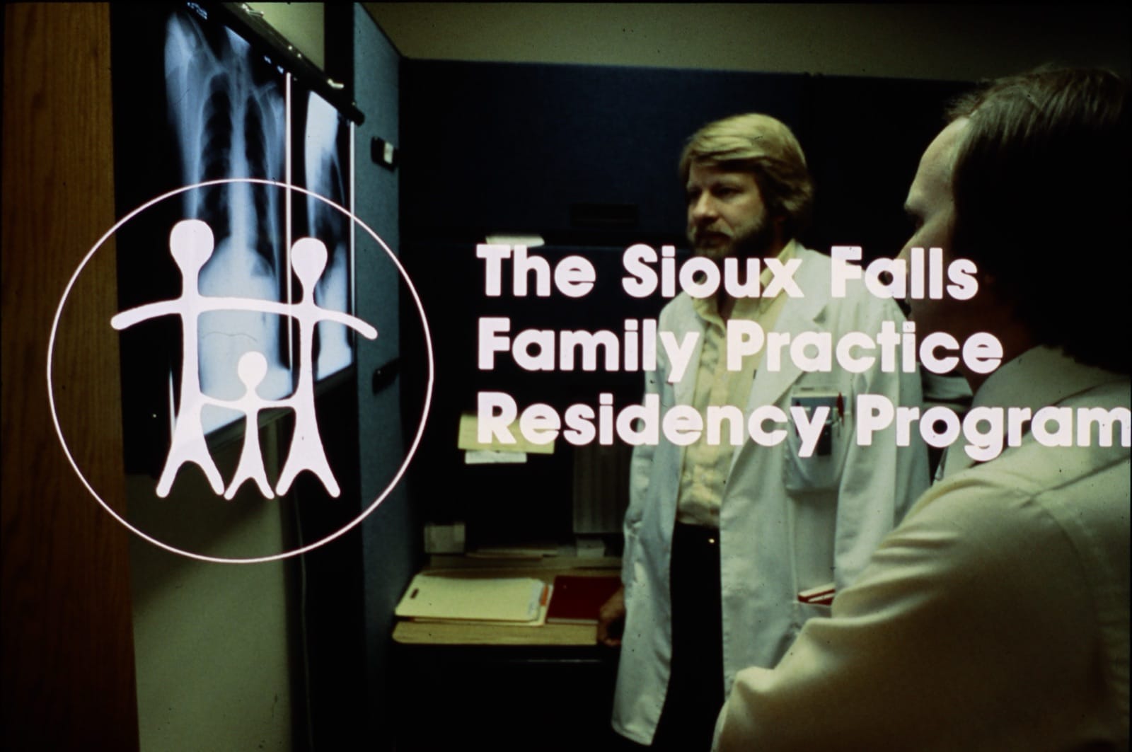 Vintage Sioux Falls Family Practice Residency Program signage with faculty reviewing chest X-rays
